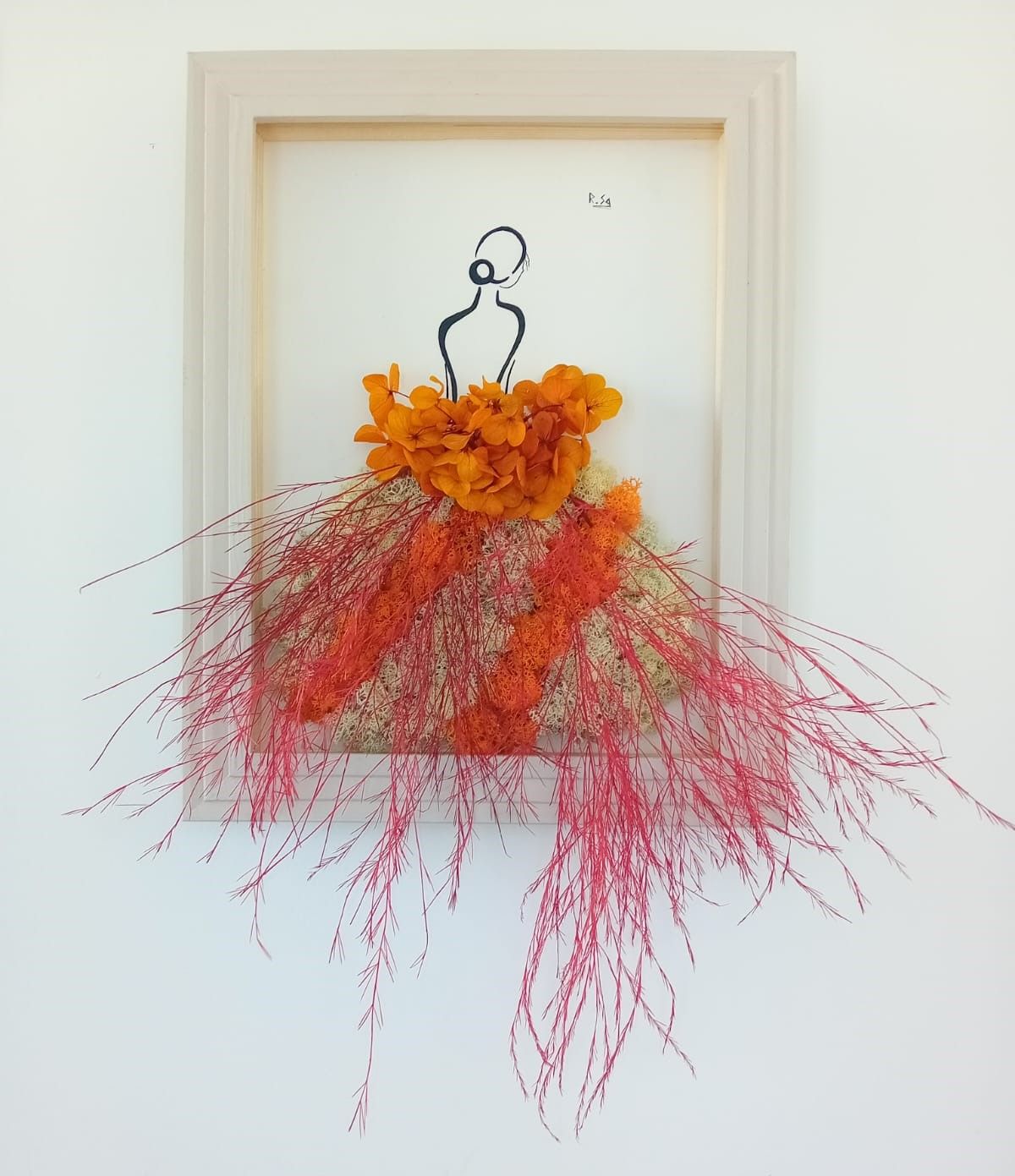 Tableau en végétaux stabilisés représentant un dame ayant une robe de bal orangé. Le corps de la dame est dessiné à  la main à l'encre de Chine noir.